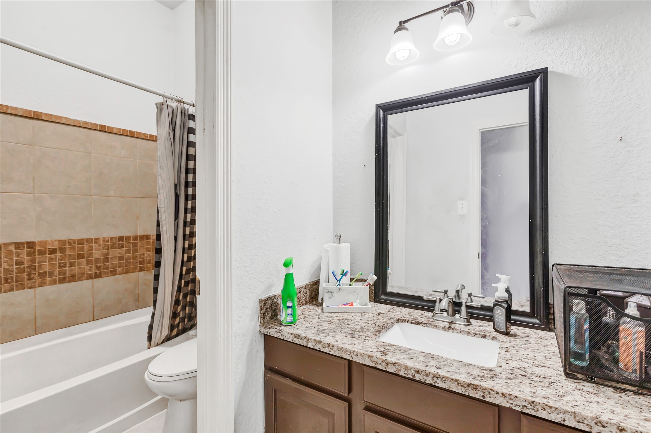 14415 Red Mulberry Lane Houston, TX 77044 - Photo 21 of 26 a bathroom with a granite countertop sink and a mirror