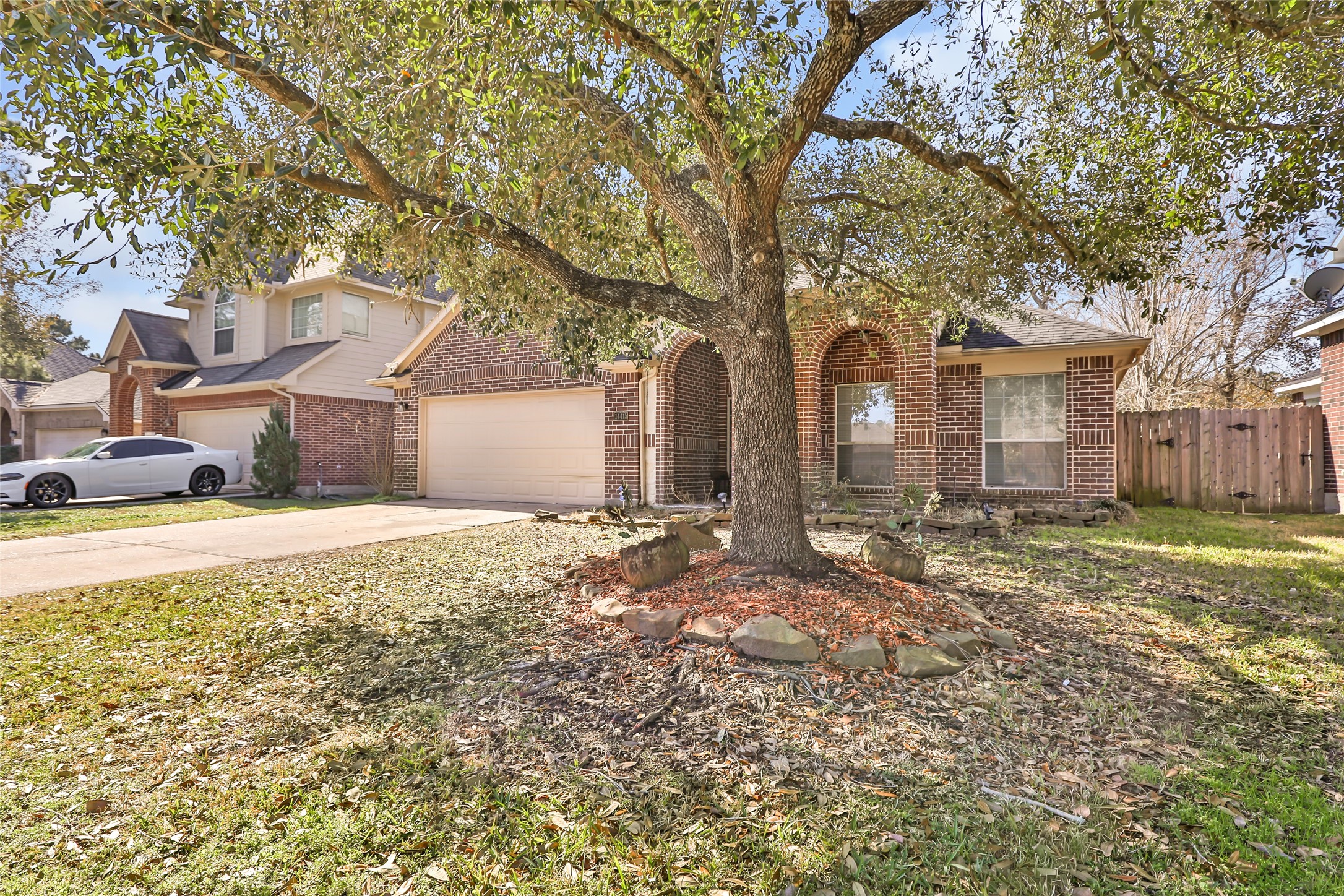 14415 Red Mulberry Lane Houston, TX 77044 - Photo 3 of 26 a front view of a house with a yard and garage
