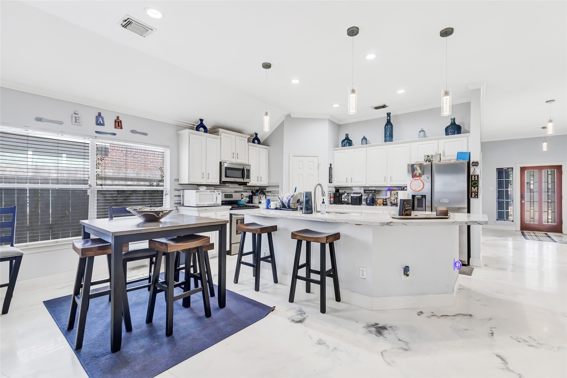 14415 Red Mulberry Lane Houston, TX 77044 - Photo 9 of 26 a kitchen with cabinets and chairs