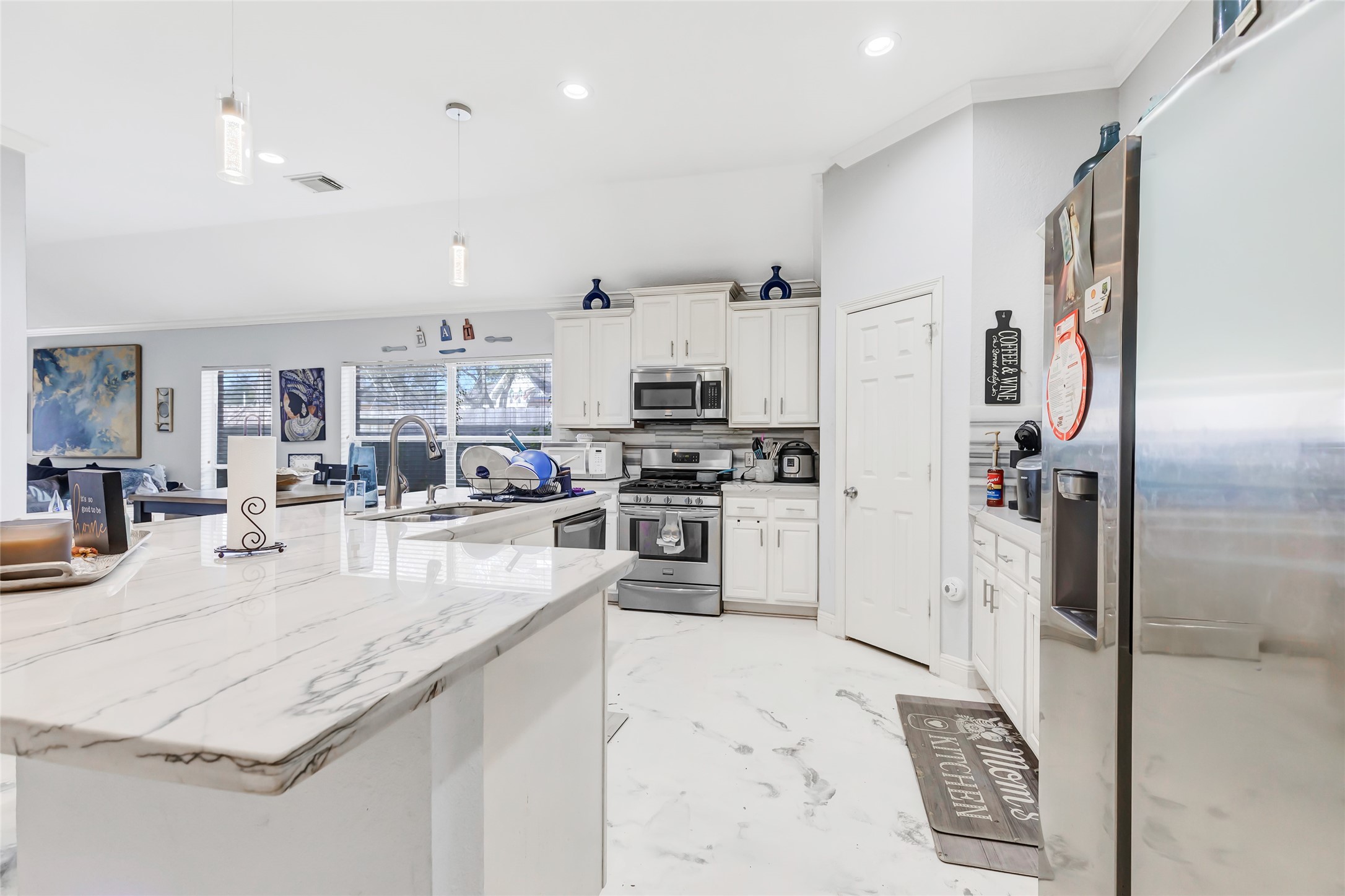 14415 Red Mulberry Lane Houston, TX 77044 - Photo 10 of 26 a large kitchen with stainless steel appliances lots of counter top space and cabinets