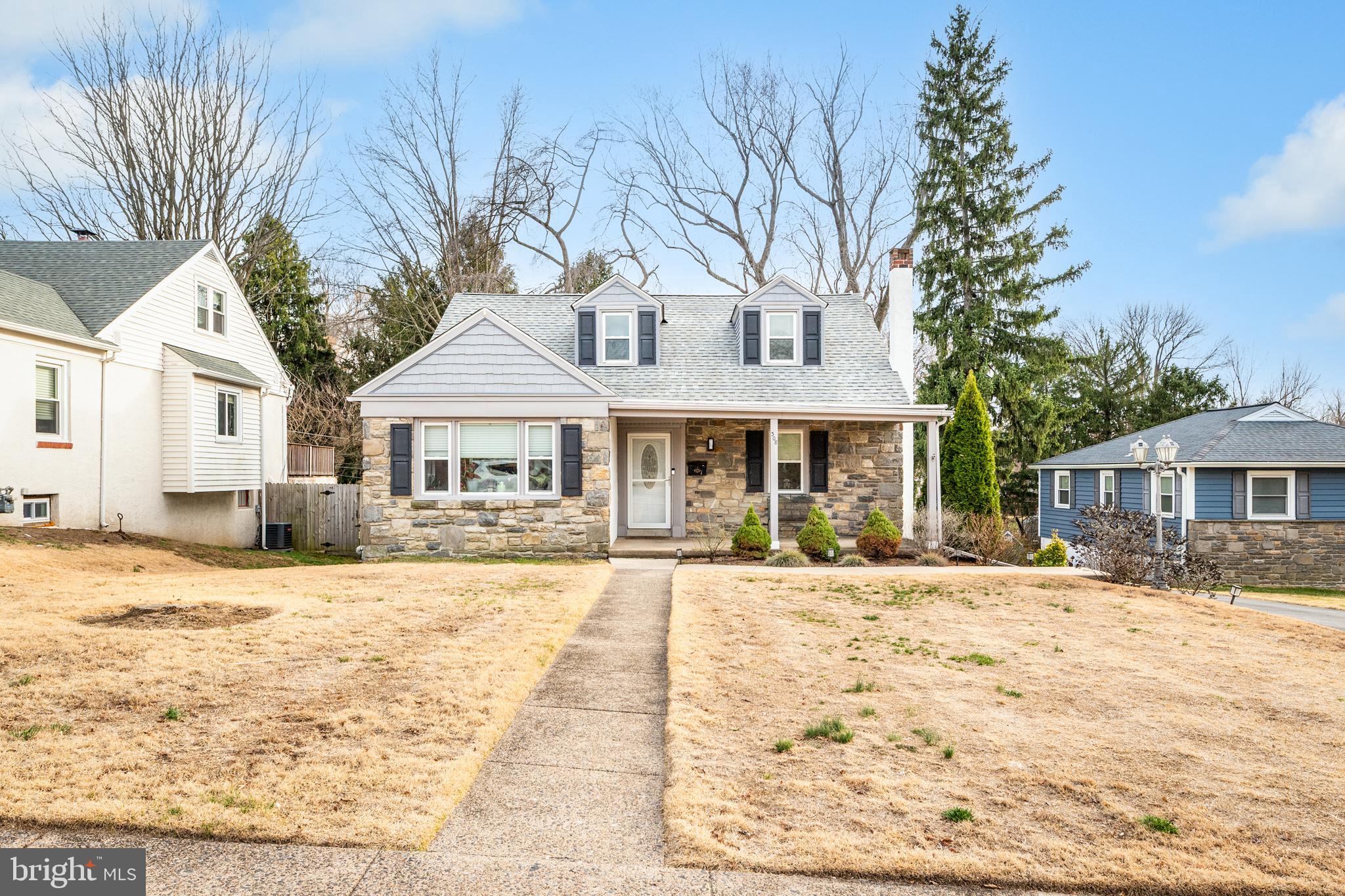 308 Providence Road Morton, PA 19070 - Photo 2 of 30 a front view of a house with a yard covered with trees