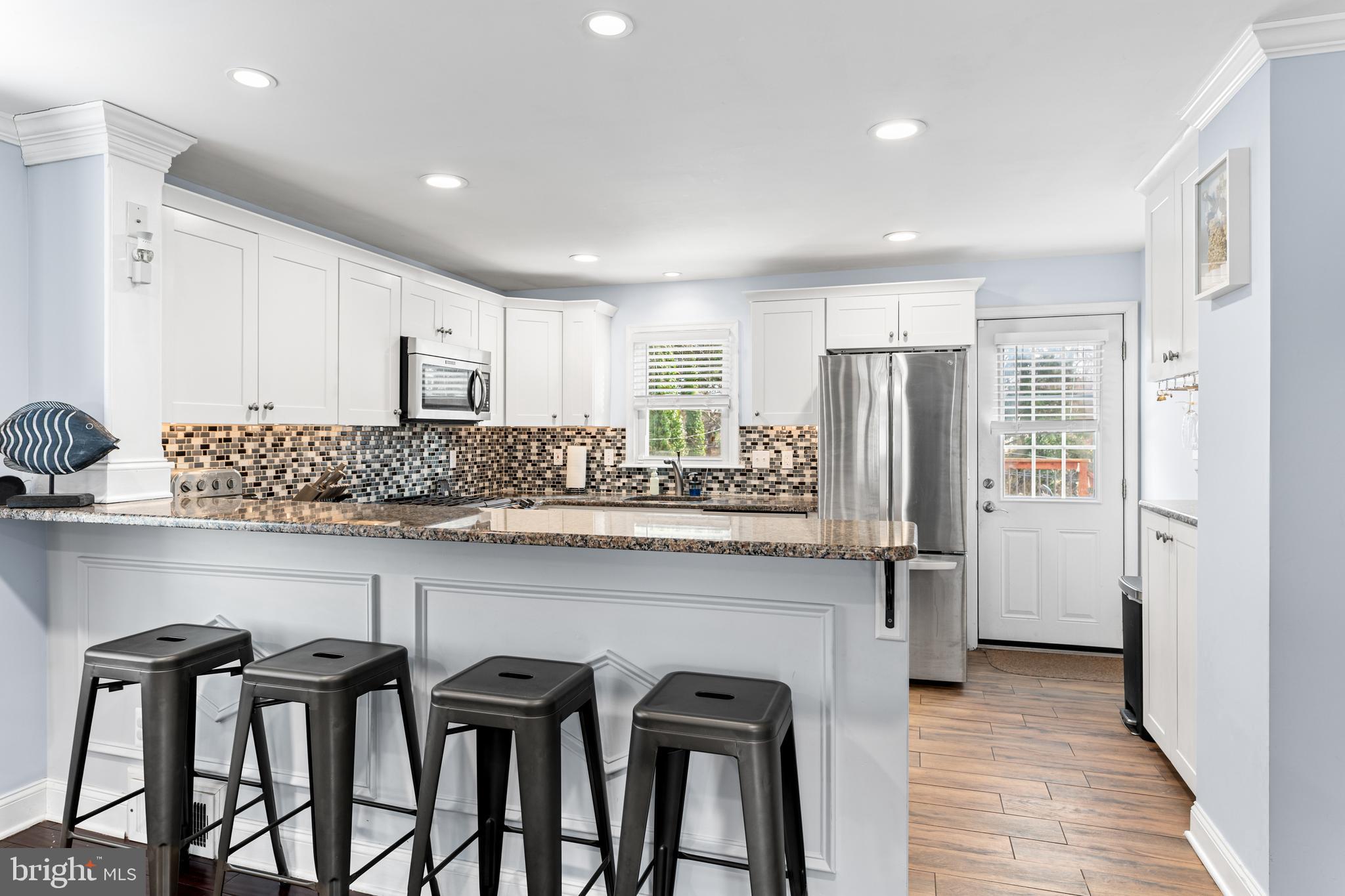 308 Providence Road Morton, PA 19070 - Photo 6 of 30 a kitchen with stainless steel appliances granite countertop white cabinets and a refrigerator