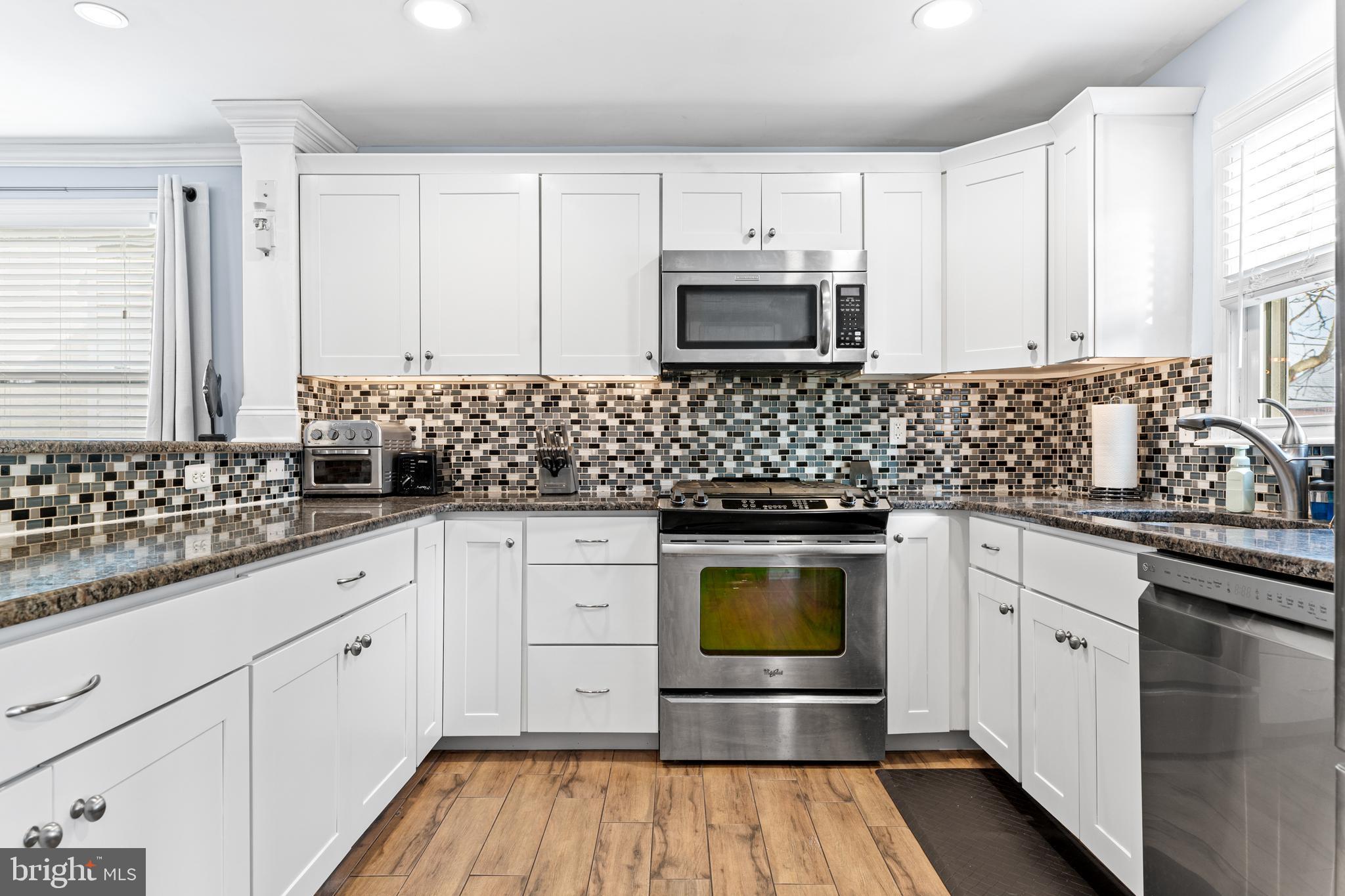 308 Providence Road Morton, PA 19070 - Photo 7 of 30 a kitchen with stainless steel appliances granite countertop white cabinets sink and stove