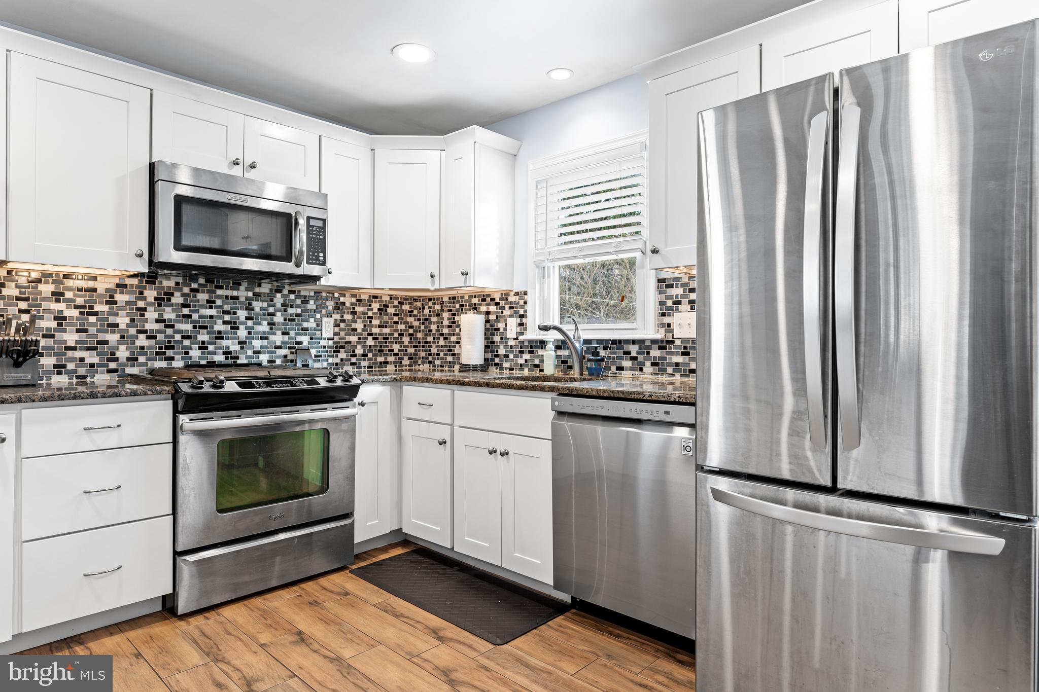 308 Providence Road Morton, PA 19070 - Photo 8 of 30 a kitchen with stainless steel appliances a stove microwave and refrigerator
