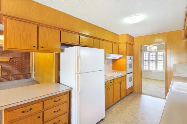 a kitchen with stainless steel appliances a refrigerator and a stove