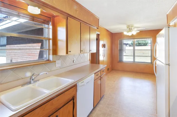 a kitchen with a sink and a large window