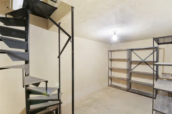 a view of a livingroom with wooden floor and windows