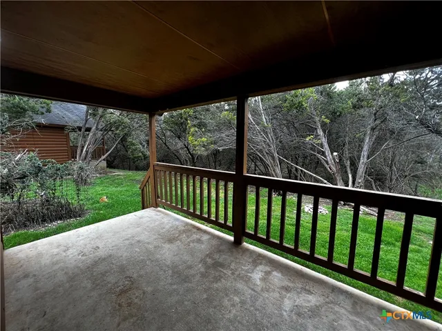 a view of a porch with a big yard
