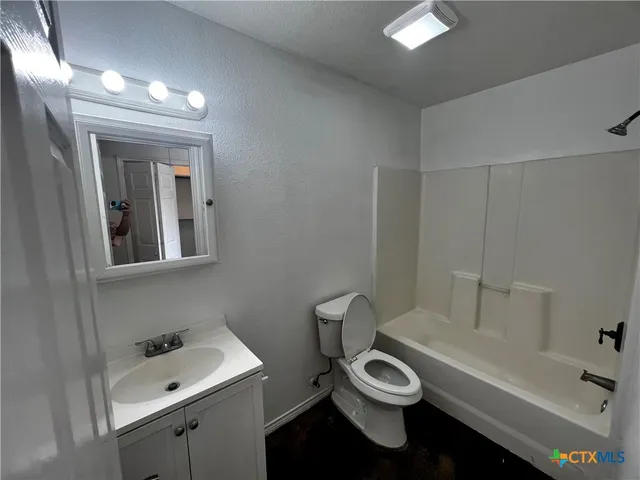a bathroom with a toilet a sink and bathtub