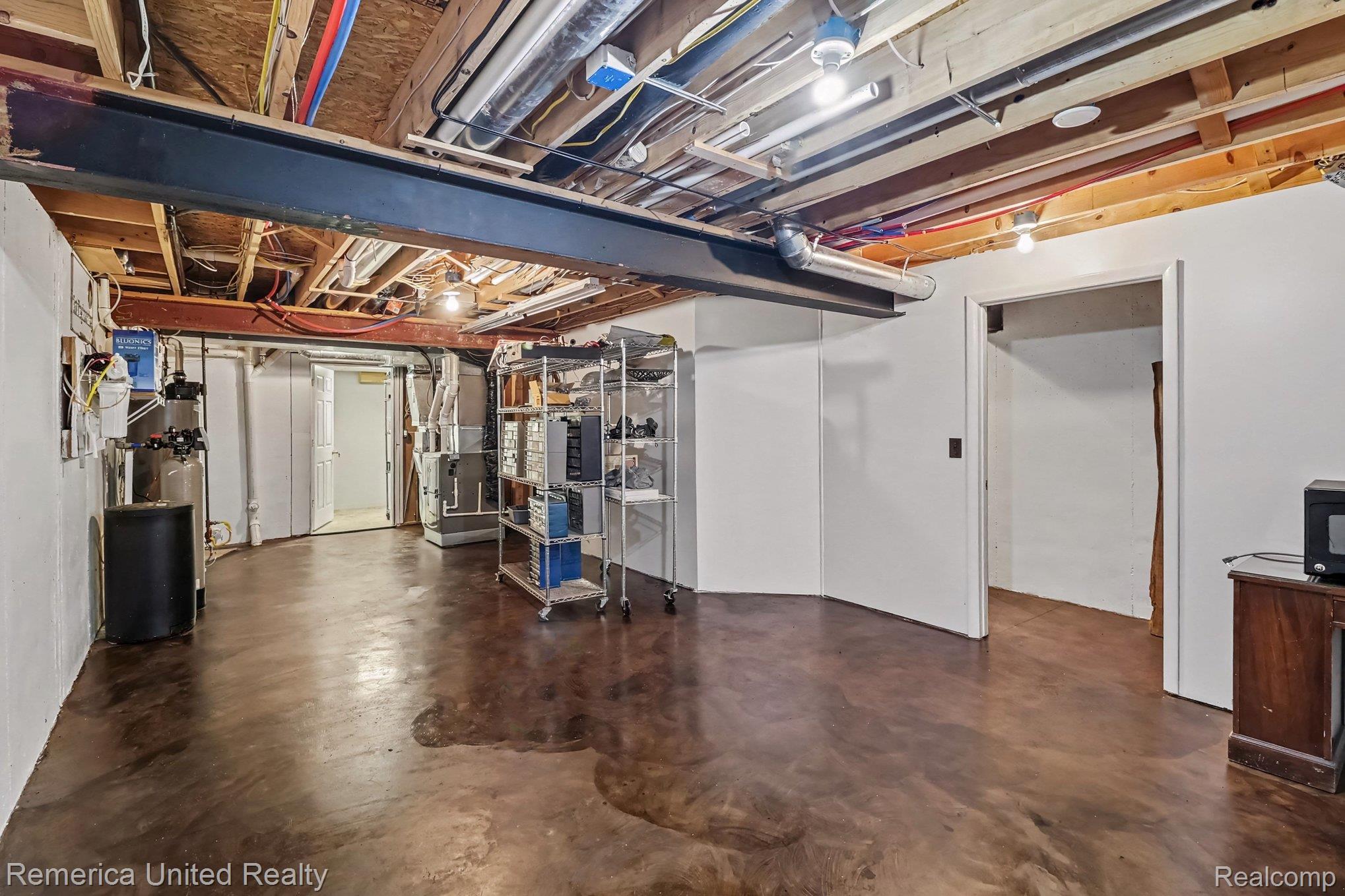 20962 Wasson Road Gregory, MI 48137 - Photo 30 of 39 Expansive utility space featuring exposed ceiling joists and ductwork, a structural steel beam, and a water filtration system