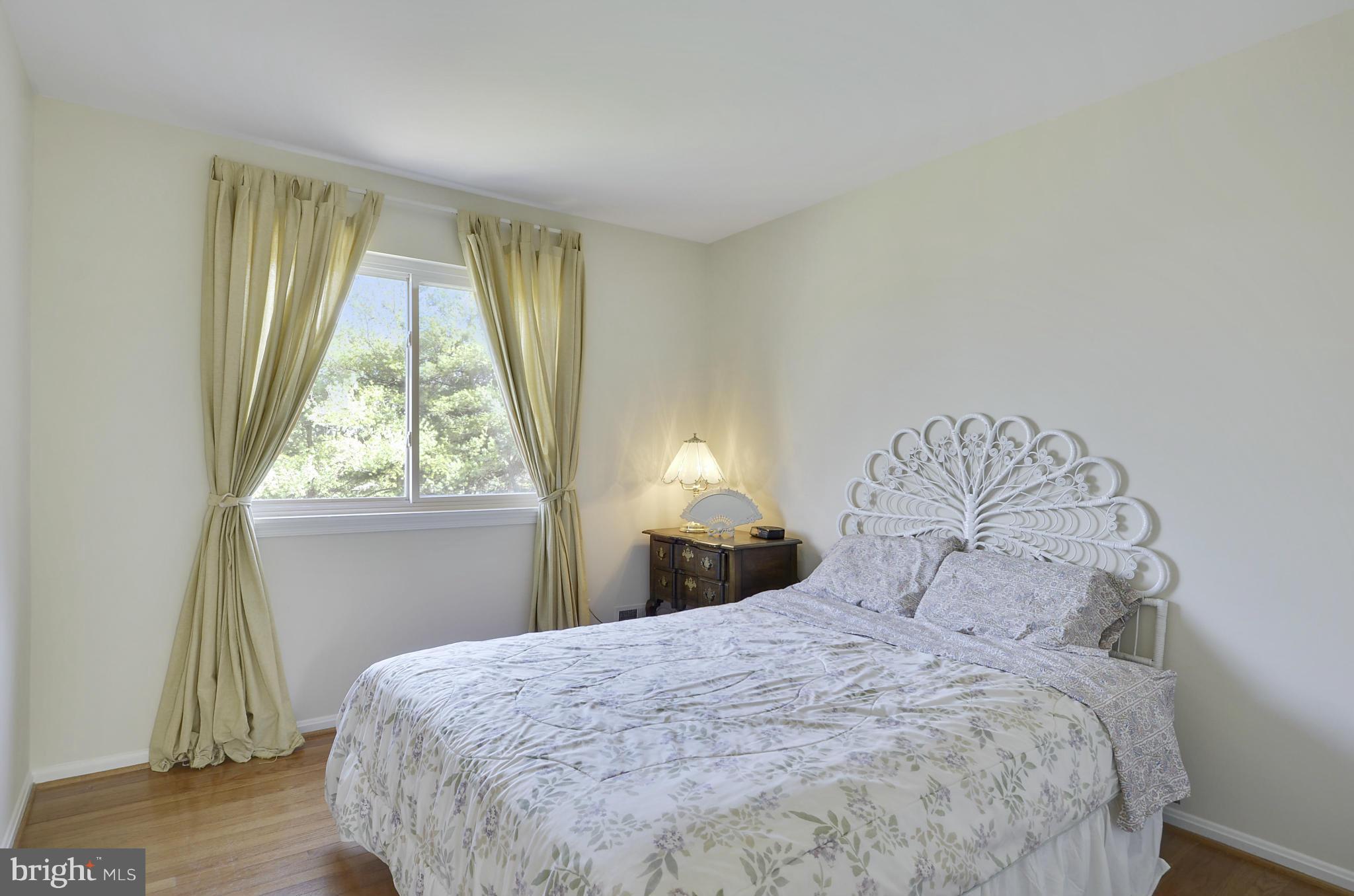 9833 Moyer Road Damascus, MD 20872 - Photo 17 of 26 a bedroom with a bed and a window