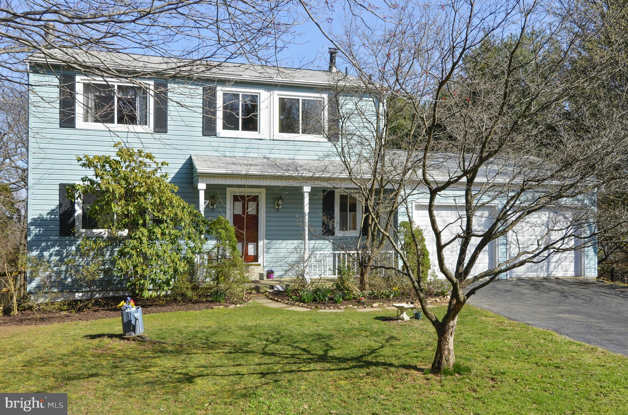 9833 Moyer Road Damascus, MD 20872 - Photo 3 of 26 a front view of a house with a yard