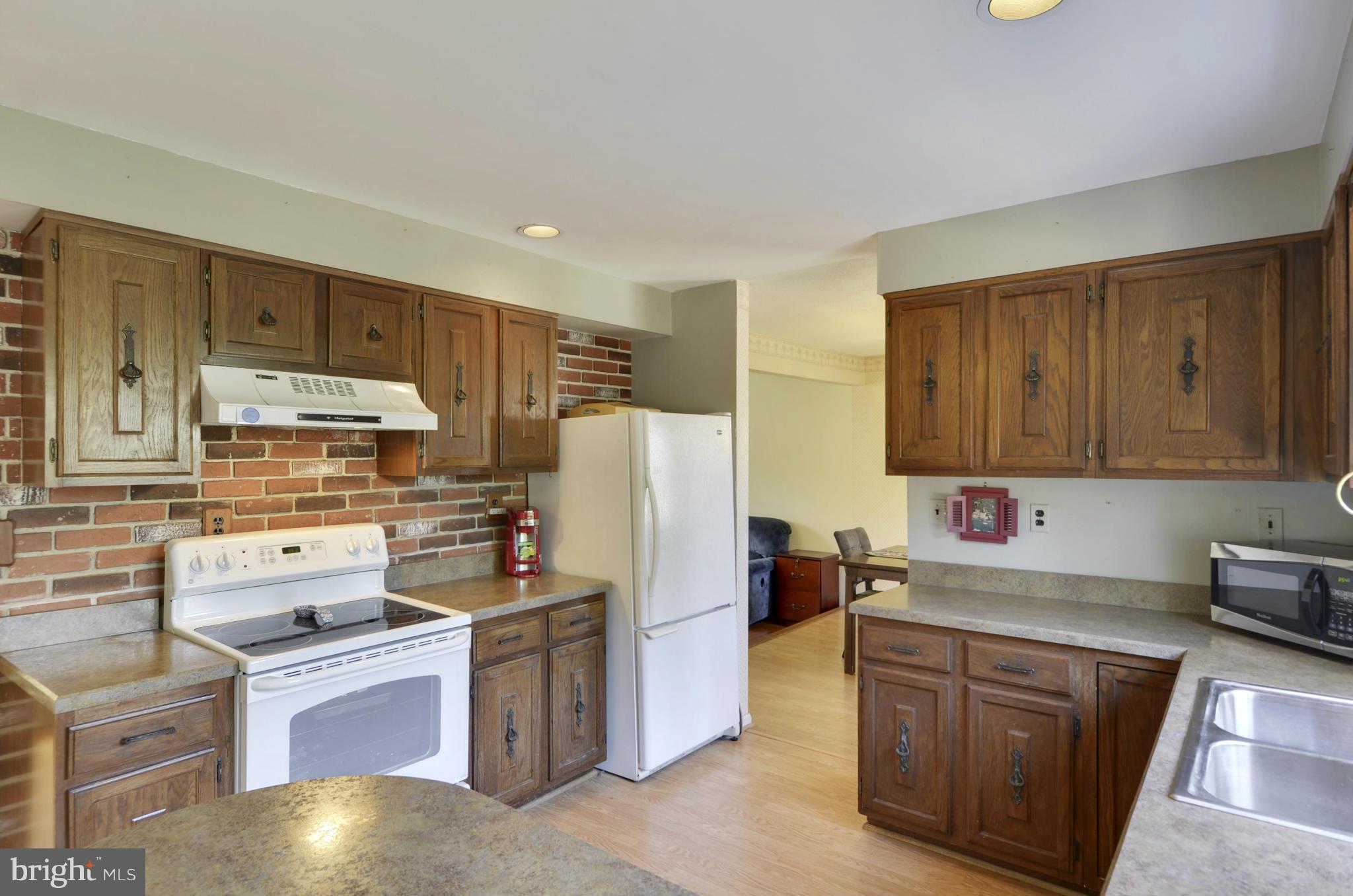 9833 Moyer Road Damascus, MD 20872 - Photo 9 of 26 a kitchen with a refrigerator stove and sink