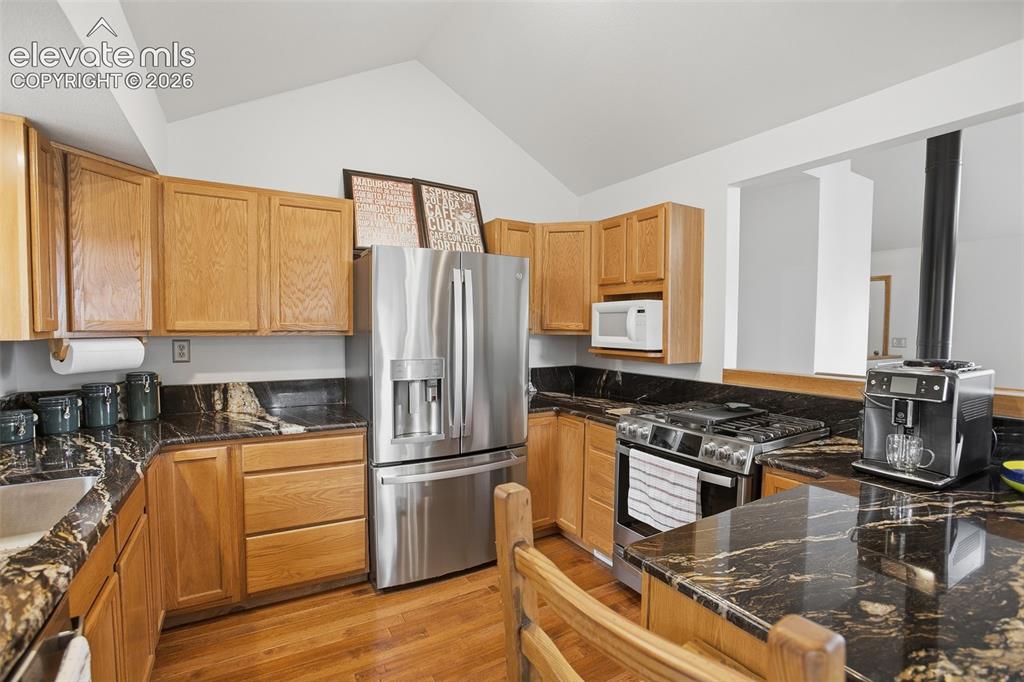 877 North Mountain Estates Road Florissant, CO 80816 - Photo 7 of 23 a kitchen with stainless steel appliances granite countertop a stove a sink and a refrigerator