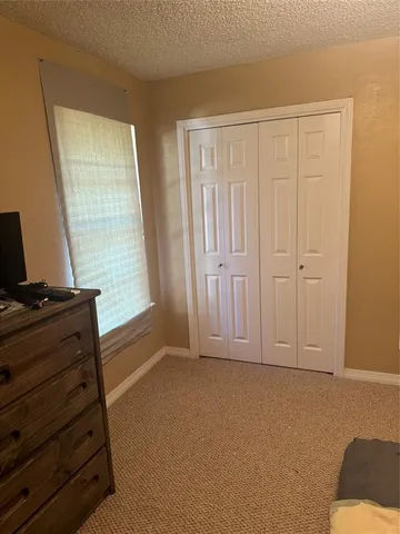 a living room with furniture and dresser with wooden floor