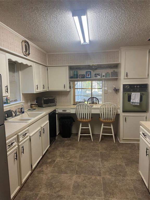 393 VZ County Road, Unit 4125 Ben Wheeler, TX 75754 - Photo 23 of 23 a kitchen with a table chairs sink and cabinets