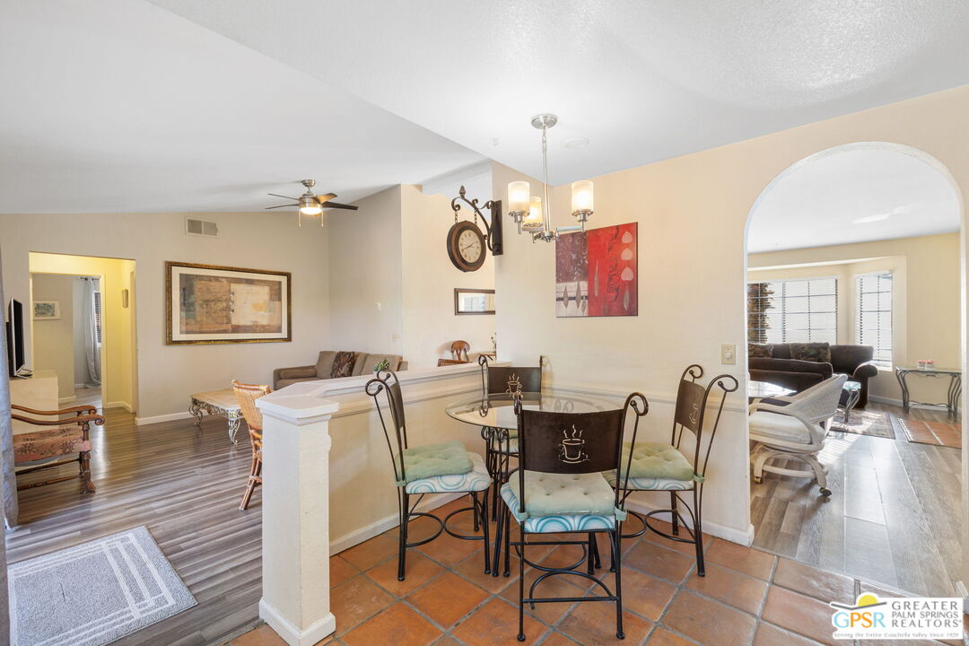 45688 Sutter Creek Road Indio, CA 92201 - Photo 16 of 51 a view of a dining room with furniture and wooden floor