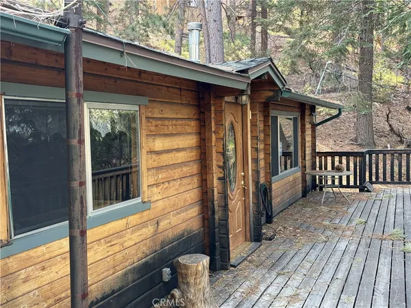 a view of a house with wooden deck