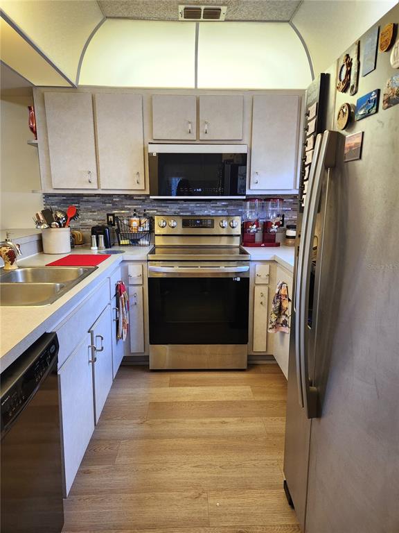 1701 Southeast 24th Road, Unit 1601 Ocala, FL 34471 - Photo 10 of 30 a kitchen with stainless steel appliances granite countertop a stove a sink and a refrigerator