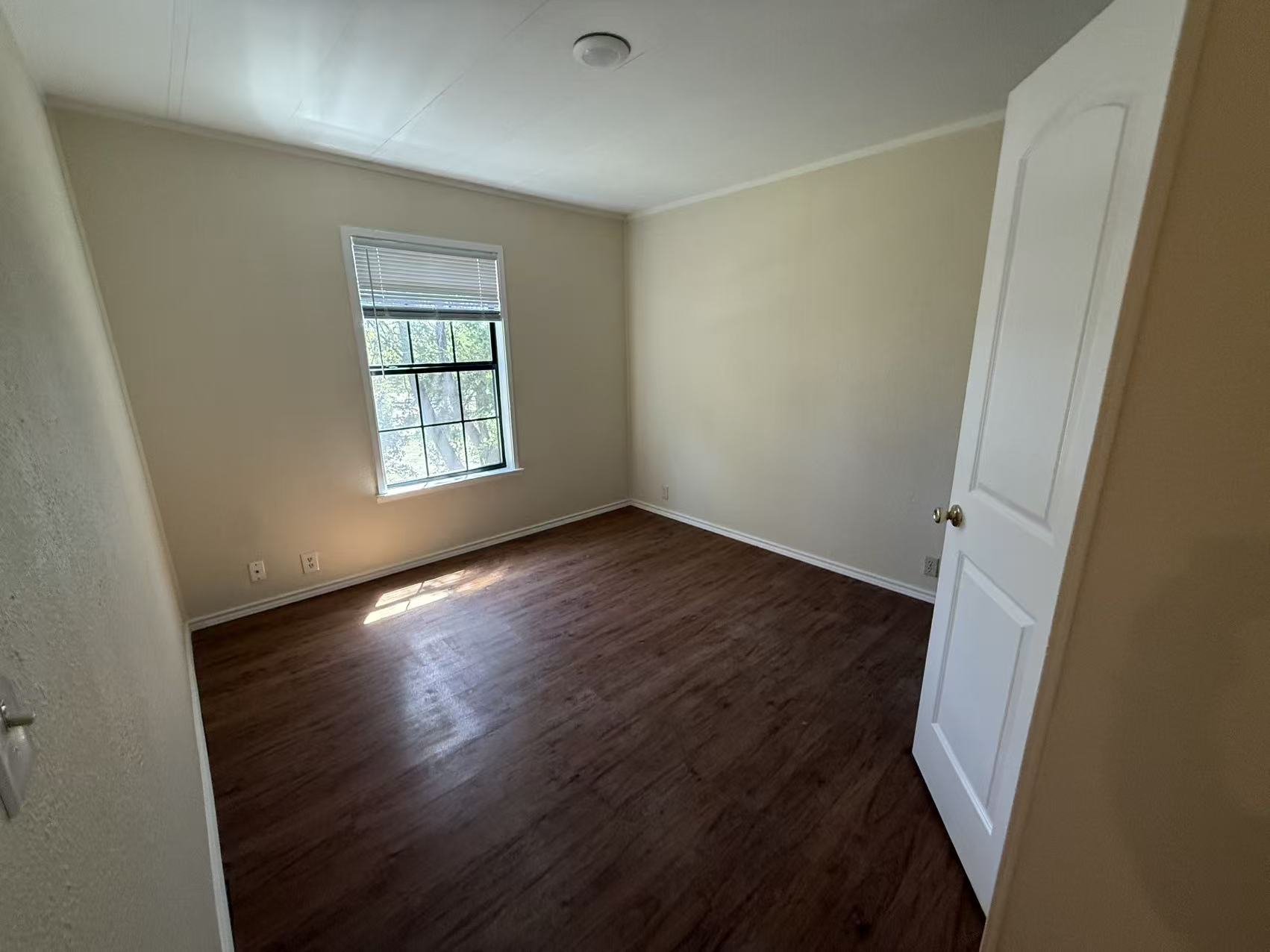 23393 Nameless Road, Unit 113 Leander, TX 78641 - Photo 15 of 16 Unfurnished room featuring dark wood-type flooring and crown molding