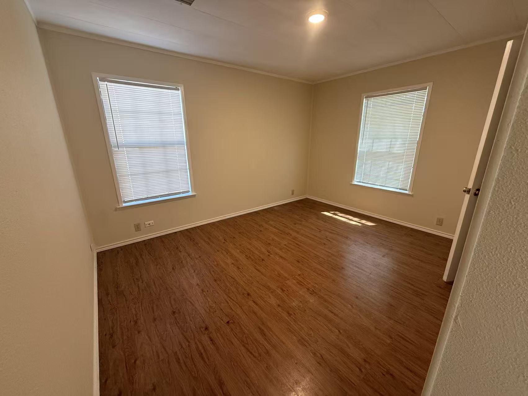 23393 Nameless Road, Unit 113 Leander, TX 78641 - Photo 4 of 16 Unfurnished room with dark wood-style flooring and ornamental molding