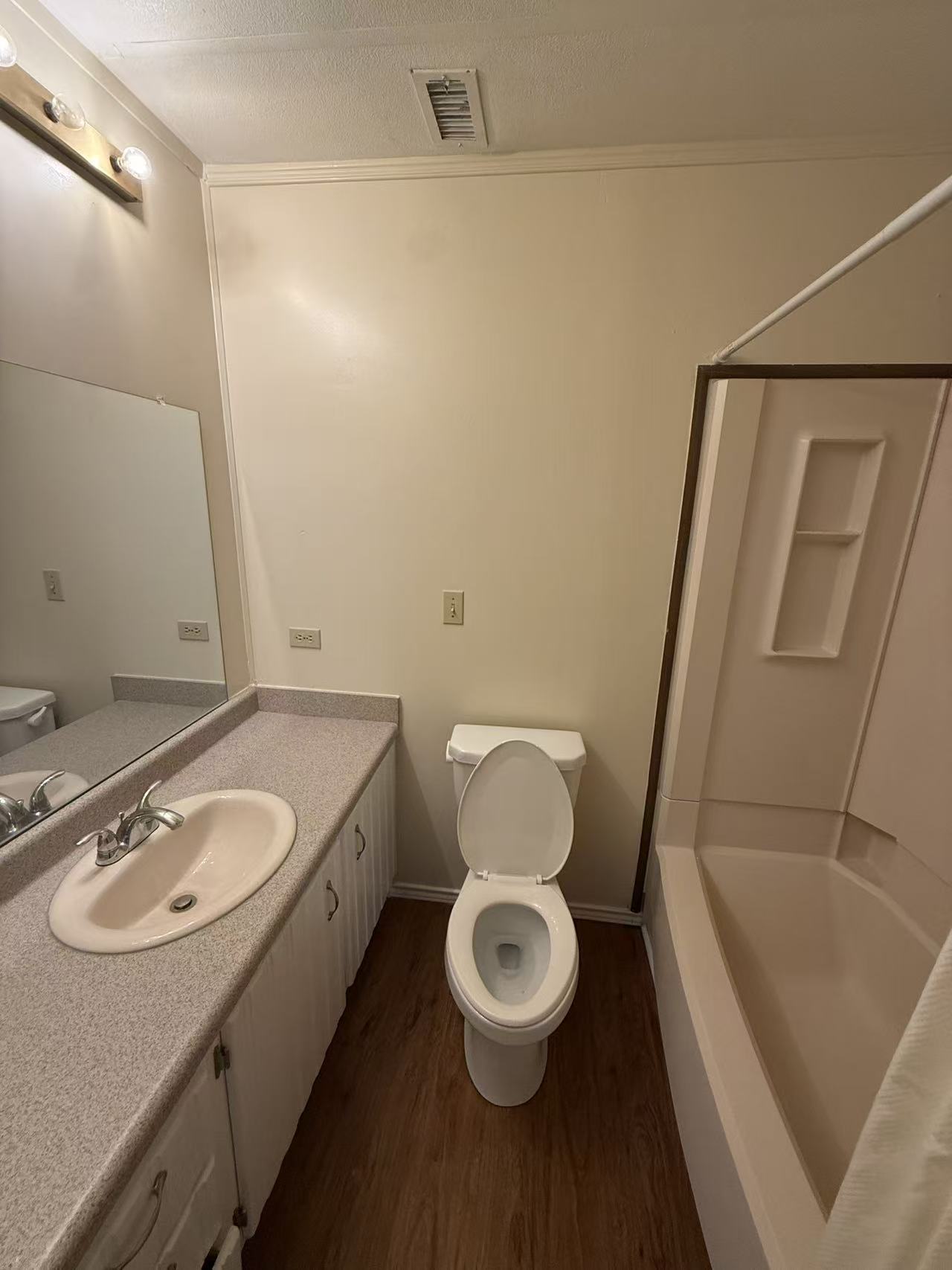 23393 Nameless Road, Unit 113 Leander, TX 78641 - Photo 6 of 16 Full bathroom with vanity, a shower, dark wood-style flooring, and ornamental molding