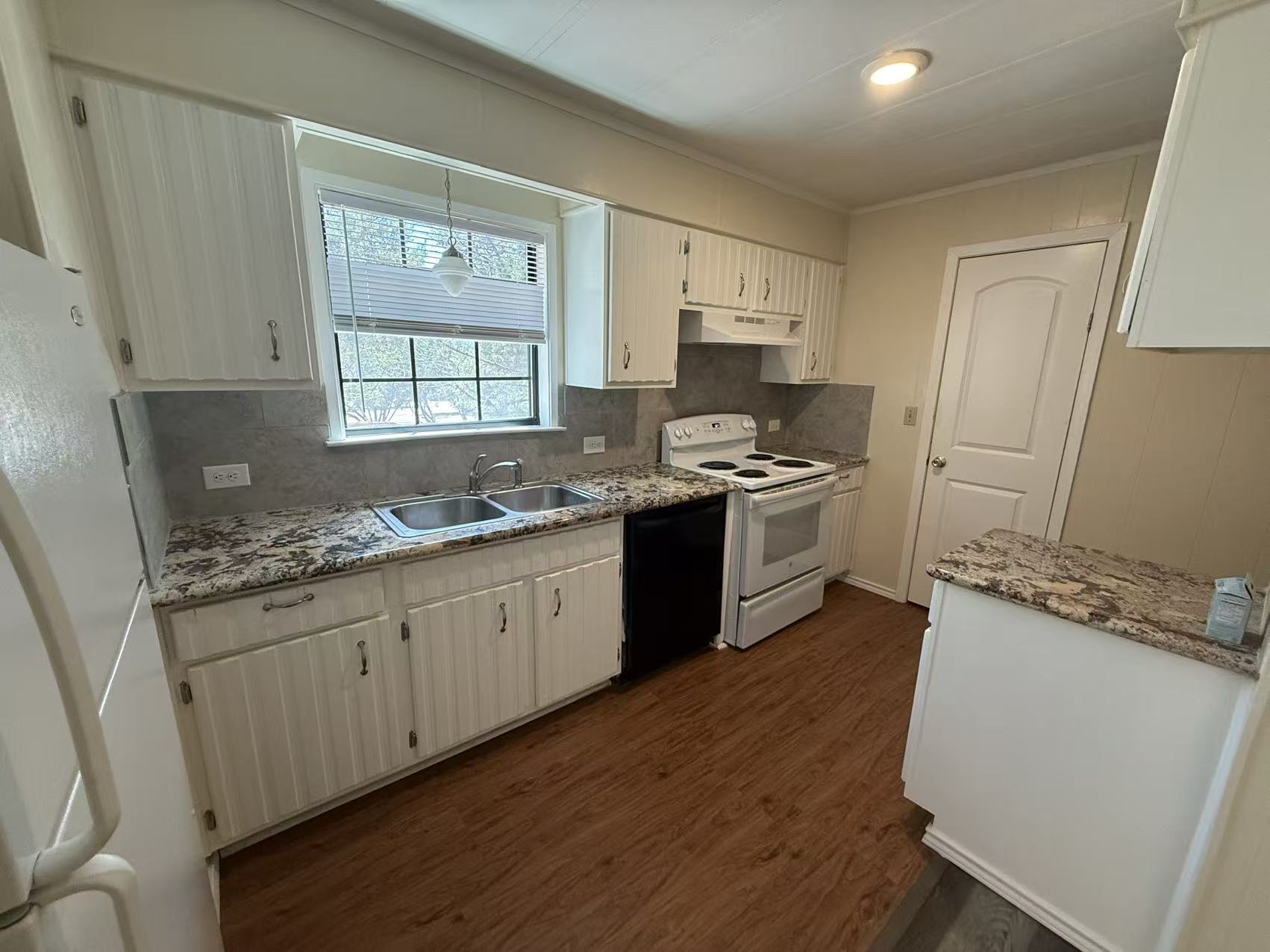 23393 Nameless Road, Unit 113 Leander, TX 78641 - Photo 8 of 16 Kitchen with white appliances, light stone countertops, and decorative backsplash