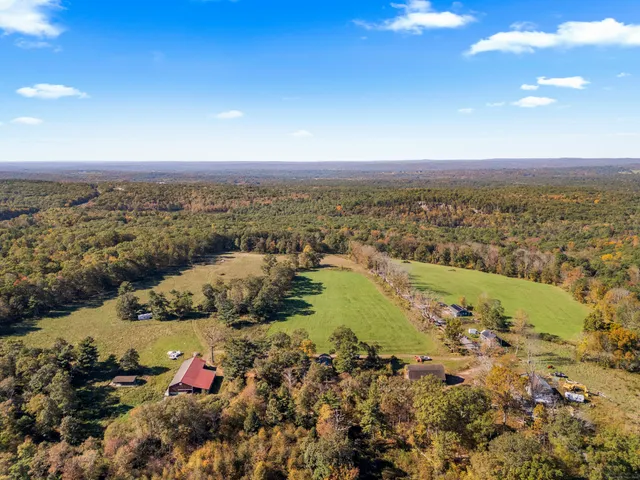 a backyard of a house with barbeque oven table and chairs