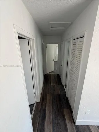 a view of a hallway and wooden floor