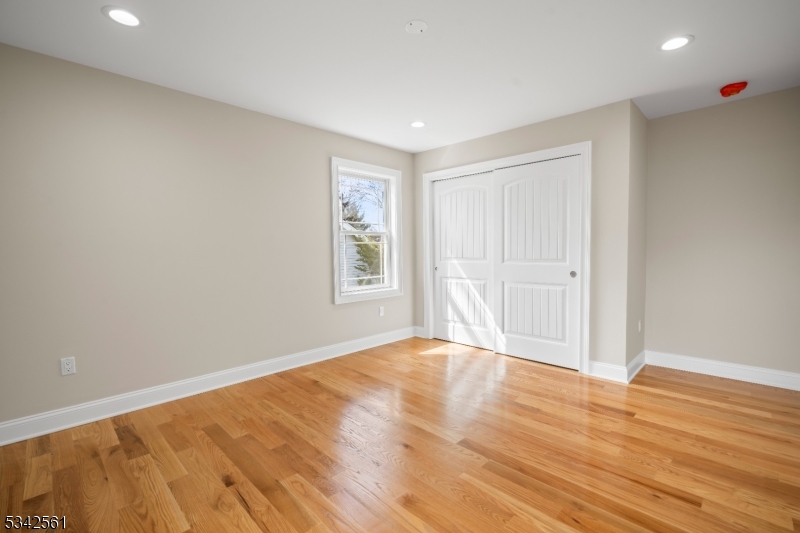 118 Cambridge Road Westfield, NJ 07090 - Photo 25 of 50 a view of an empty room with wooden floor and a window
