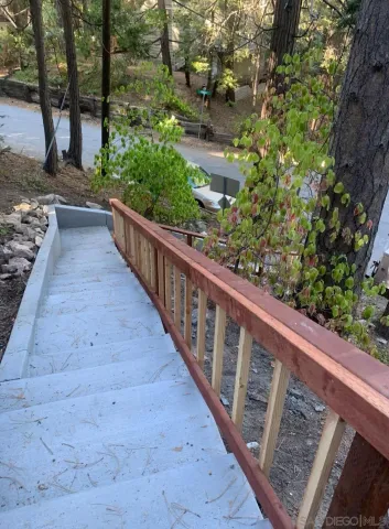 a view of a balcony with wooden fence