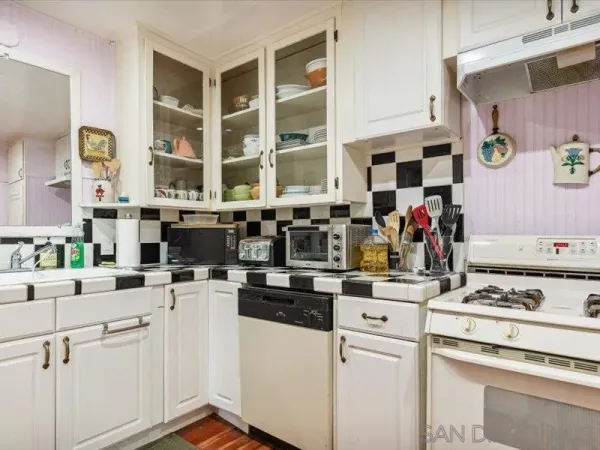 a kitchen with appliances a sink and a stove
