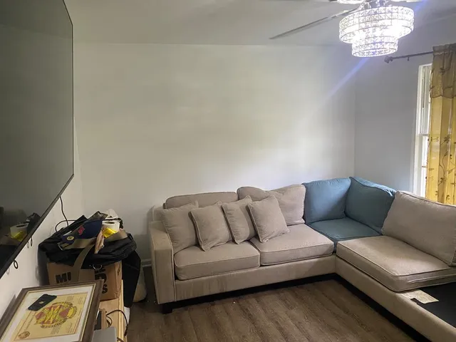 an empty room with wooden floor and cabinet