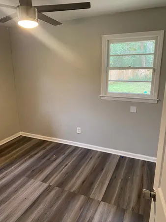a bed sitting in a bedroom next to a window