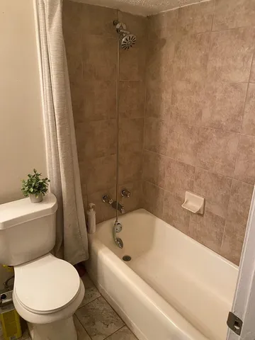 a bathroom with a toilet and shower