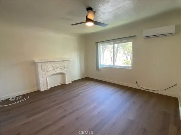 wooden floor in an empty room with a fireplace