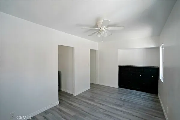 a view of an empty room and wooden floor