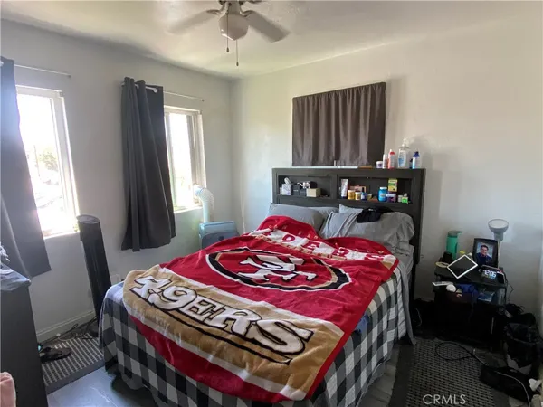 a bed room with a bed window and chair