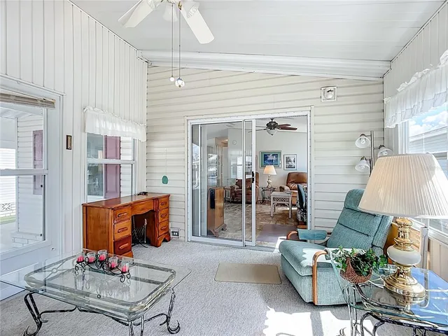 a living room with furniture a dining table and a chandelier