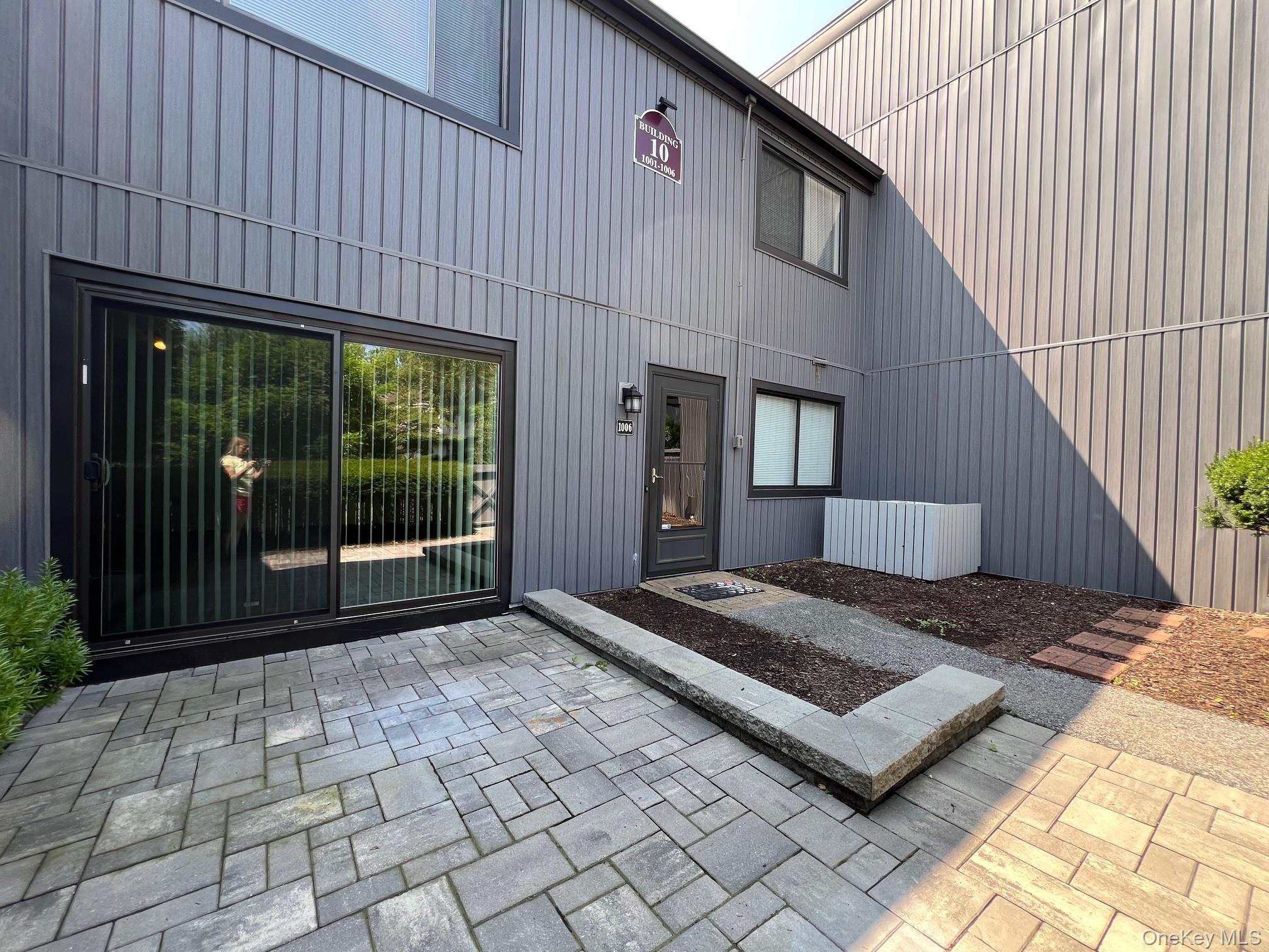 Doorway to property featuring a patio area