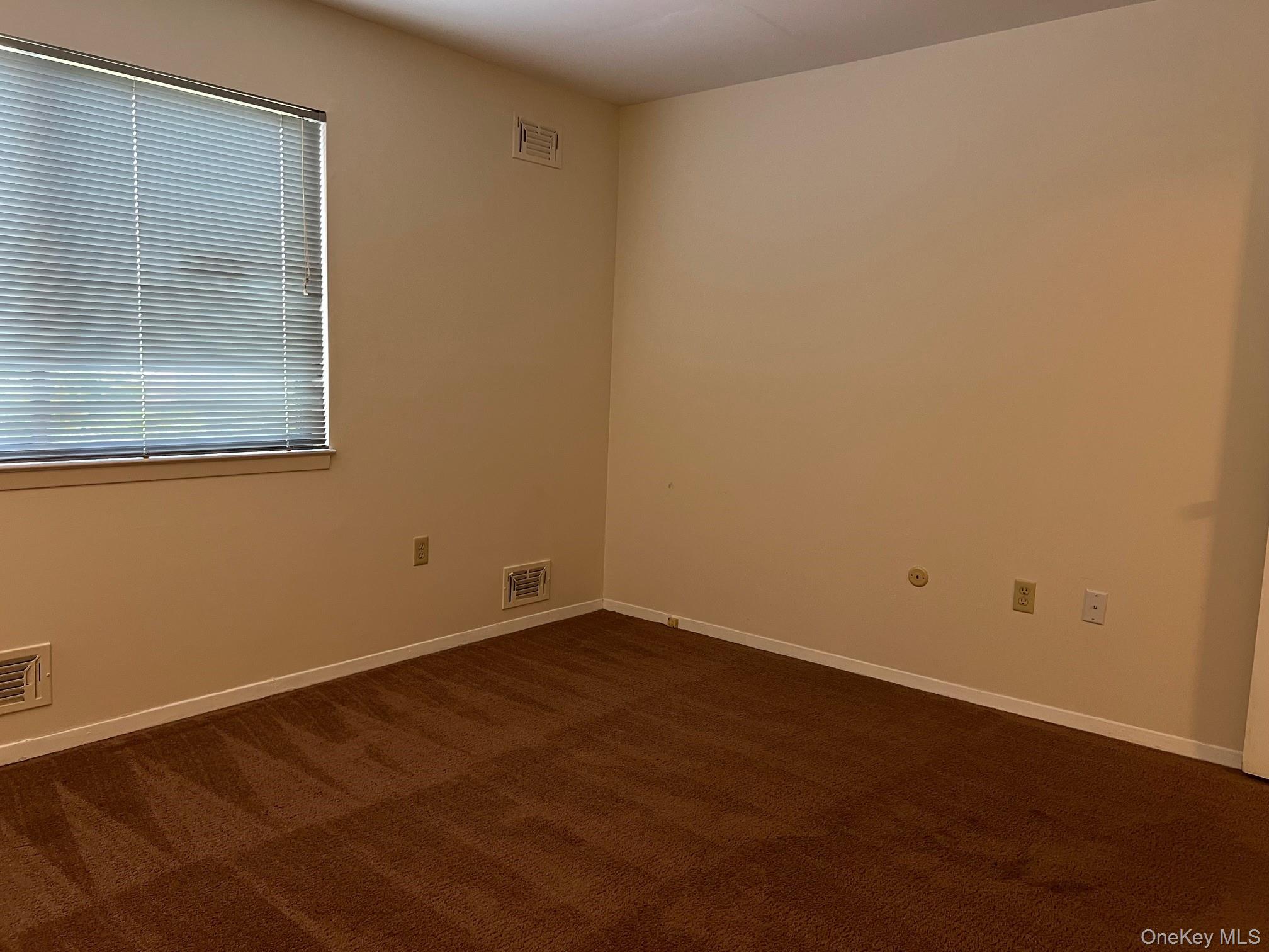 1006 Holly Walk Poughkeepsie, NY 12603 - Photo 12 of 18 Unfurnished room with dark carpet and baseboards