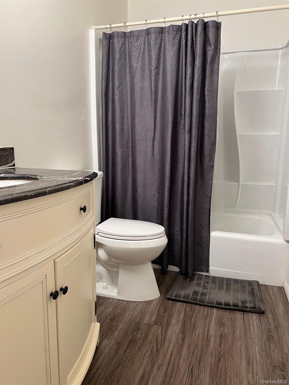 1006 Holly Walk Poughkeepsie, NY 12603 - Photo 16 of 18 Bathroom featuring shower / bath combo, vanity, and dark wood-style flooring