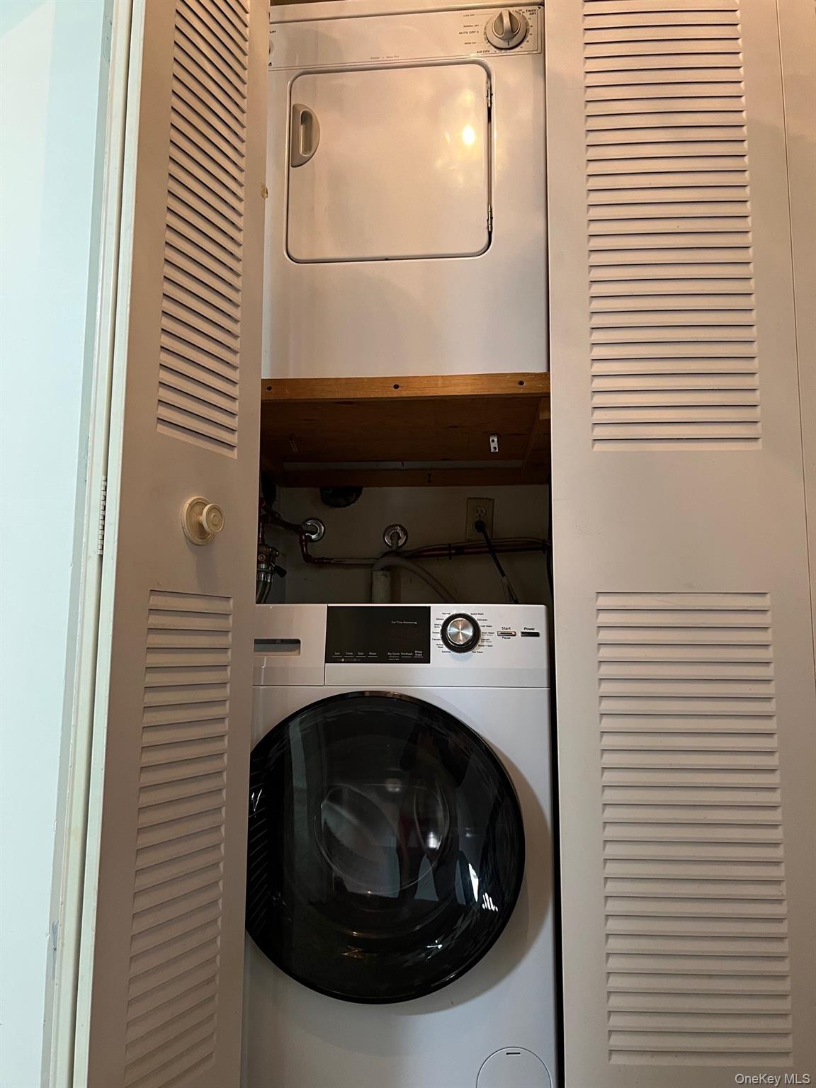 1006 Holly Walk Poughkeepsie, NY 12603 - Photo 18 of 18 Laundry area featuring stacked washer and clothes dryer