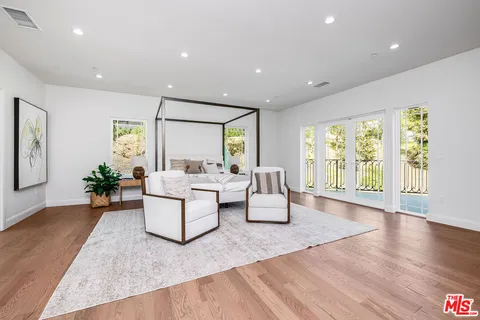 a view of a chairs and table in the balcony