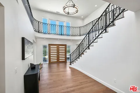 a living room with furniture and a dining table