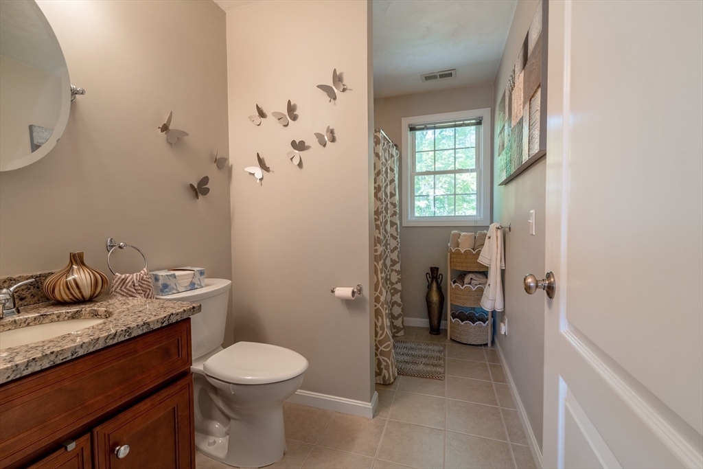22 Duluth Street Worcester, MA 01604 - Photo 14 of 35 a bathroom with a granite countertop toilet and a sink