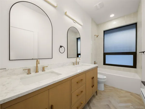 a bathroom with a double vanity sink and a mirror