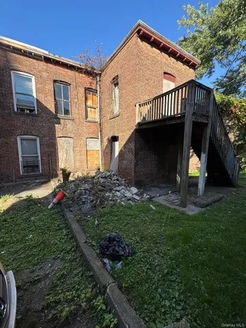 a view of a house with a yard and a garden
