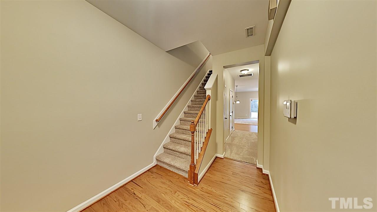 2238 Stoney Spring Drive Raleigh, NC 27610 - Photo 2 of 11 a view of a hallway with wooden floor and staircase