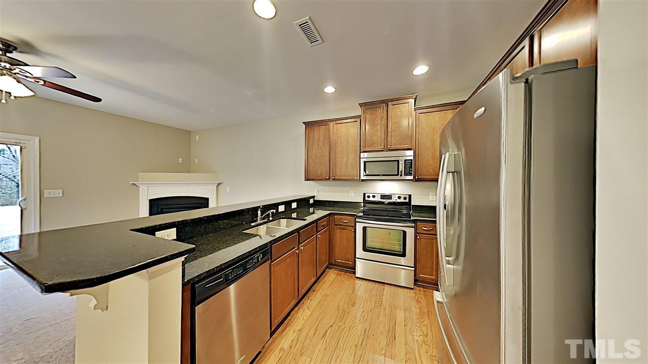 2238 Stoney Spring Drive Raleigh, NC 27610 - Photo 4 of 11 a kitchen with granite countertop a sink appliances and cabinets